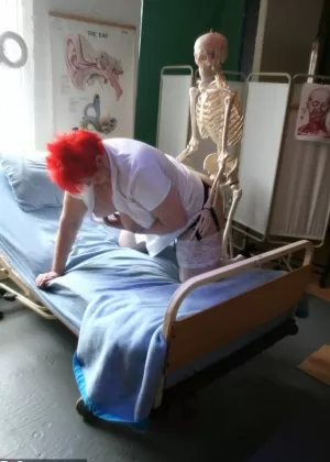 Slutty mature nurse in white stockings gets toyed up by a skeleton