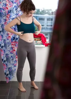 Lustful brunette amateur Livia V getting dressed after an orgasm