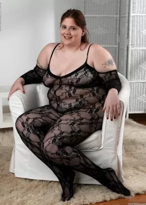 Fat solo girl toys her vagina while slipping out of crotchless bodystocking