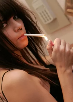 Skinny teen Kaira 18 smokes a cigarette before stripping naked