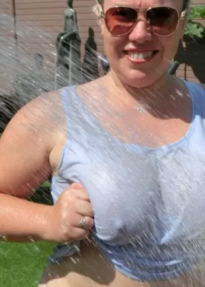 Older blonde Barby loses her big tits from a bikini before fingering her pussy