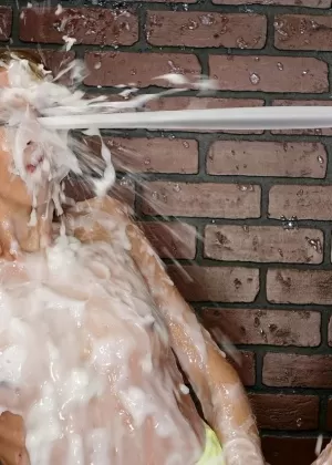 European female in pigtails gets covered in sperm at a gloryhole