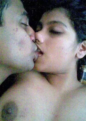 Busty Indian woman joins her man friend for foreplay on bed