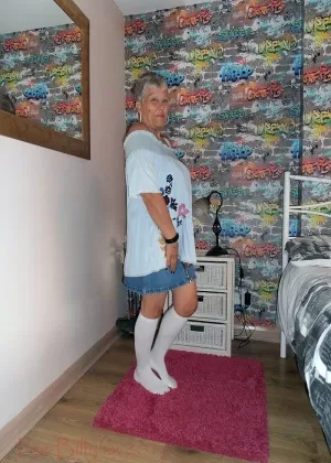Silver haired granny Savana strips down to white knee socks in her bedroom