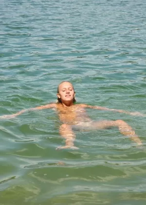 Nude teen girl Sara J comes ashore to masturbate her horny pussy